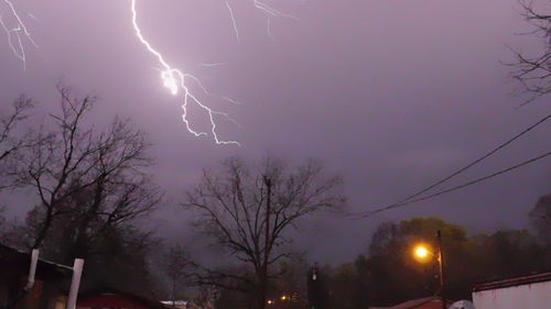 Low angle view of illuminated street light against sky at night