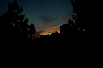 Silhouette built structures at sunset