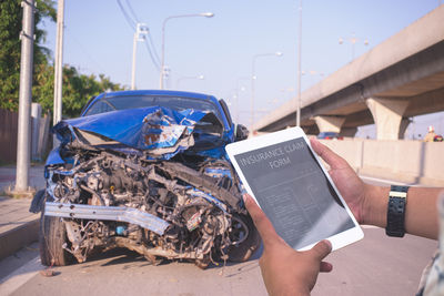 Midsection of man using mobile phone
