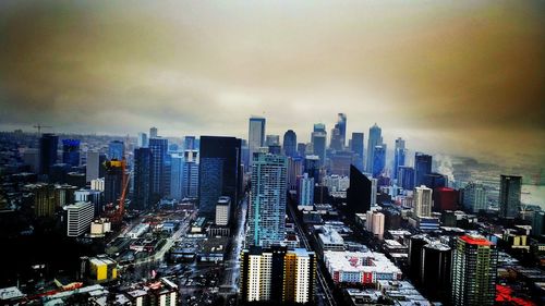 Aerial view of illuminated cityscape against sky