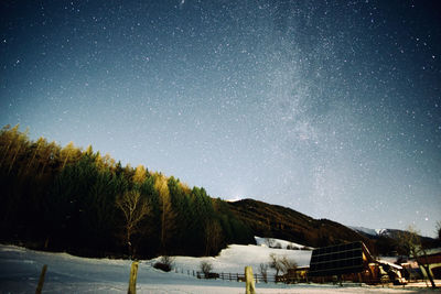 Scenic view of snowcapped mountains against sky at night