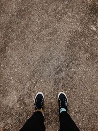 Low section of man standing on ground