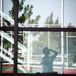 Woman looking through window