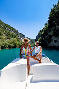 Full length of woman on boat against blue sky