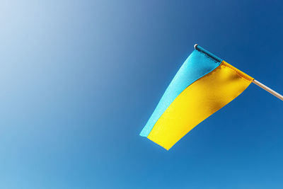 Large bicolor yellow blue ukrainian state flag, national symbol fluttering, waving in wind sky