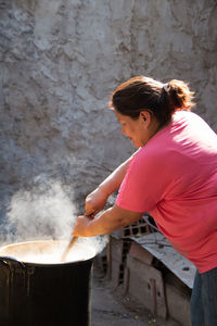 Portrait of south american woman preparing traditional food outdoors