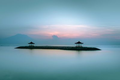 Silhouette boat in sea against sky during sunset