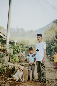 Portrait of young man standing on field