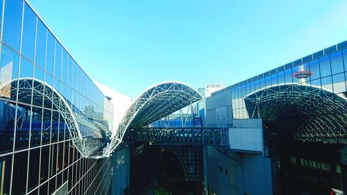 Low angle view of modern buildings against blue sky