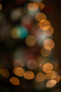 Defocused image of illuminated christmas lights at night