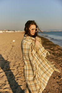 Young woman standing at beach