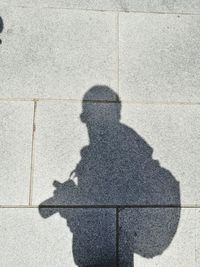 Shadow of man on tiled floor