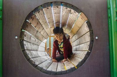 View of child playing on playground equipment