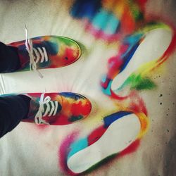 Low section of person standing on tiled floor