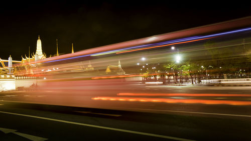 Light trails on road in city at night