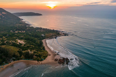 Aerial view of sea against sky during sunset