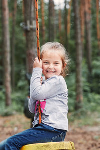 Portrait of smiling girl sitting on land