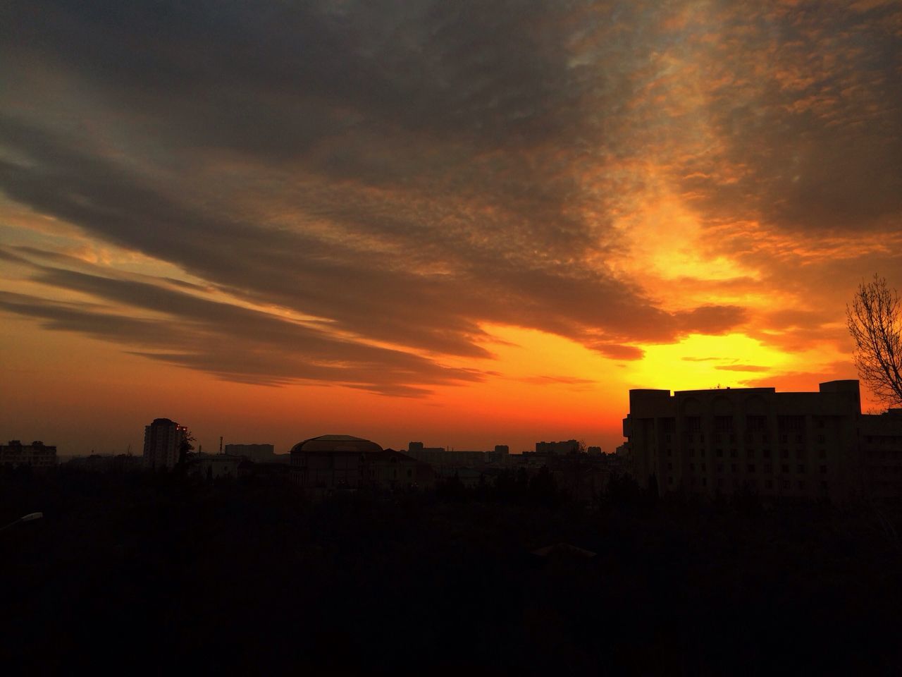 sunset, silhouette, orange color, building exterior, architecture, sky, built structure, cloud - sky, beauty in nature, dramatic sky, scenics, city, cloudy, nature, cloud, building, dark, moody sky, residential structure, residential building