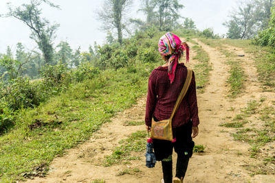 Full length of woman walking on field