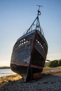 Sailboat on beach against sky