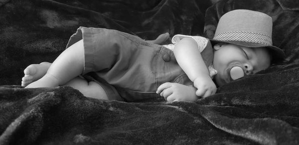 Close-up of baby boy sleeping on bed