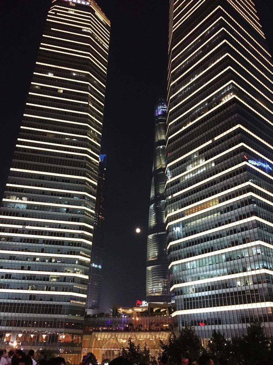 LOW ANGLE VIEW OF ILLUMINATED BUILDINGS AGAINST SKY