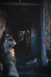 Portrait of a man holding camera in building