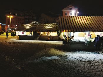 People in illuminated city at night