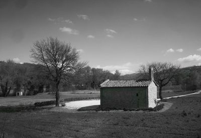 Built structure on field against sky