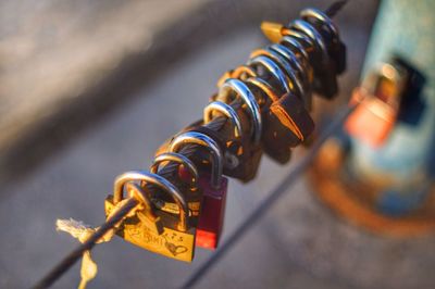 Close-up of padlocks on steel cable