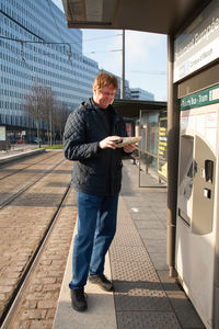 Full length of man using mobile phone