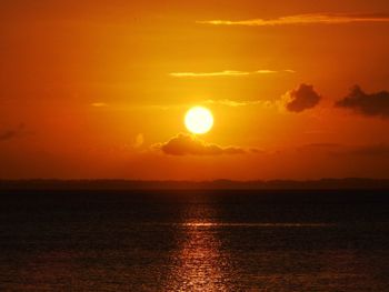 Scenic view of sea against romantic sky at sunset