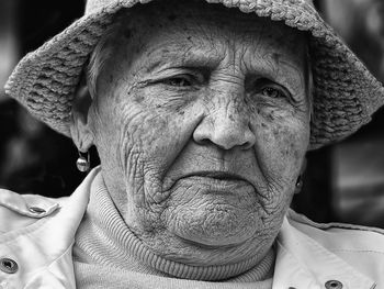 Close-up of thoughtful senior woman wearing hat