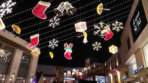 Low angle view of illuminated lanterns hanging at store