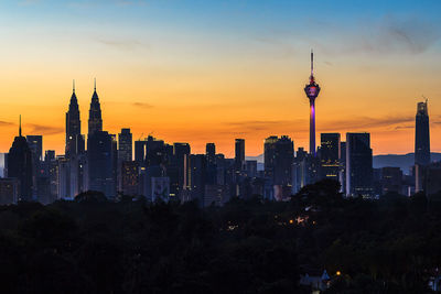 View of buildings in city during sunset