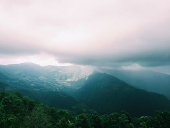 Scenic view of mountains against cloudy sky