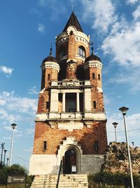 Low angle view of bell tower against cloudy sky