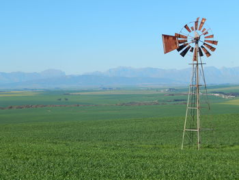 Scenic view of field against cloudy sky