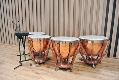 Close-up of drums against wall