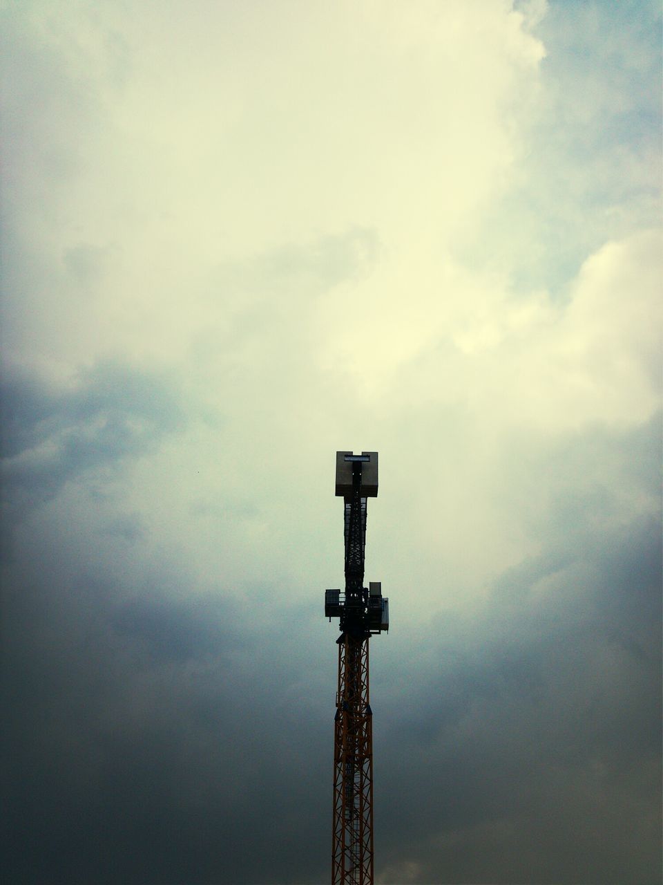 low angle view, sky, cloud - sky, cloudy, metal, tall - high, built structure, industry, tower, cloud, weather, crane - construction machinery, communications tower, overcast, development, architecture, day, no people, technology, metallic