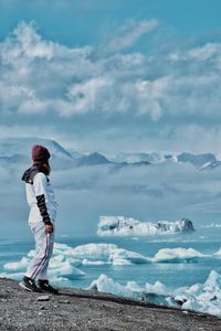 Man standing on mountain against sky