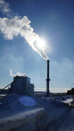 View of factory against blue sky