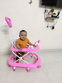 Portrait of cute baby sitting on floor