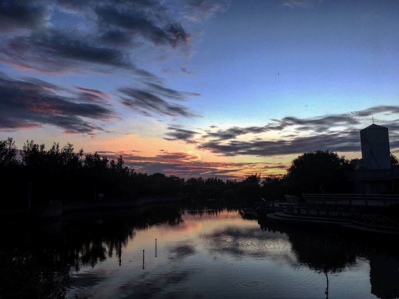 REFLECTION OF CLOUDS IN LAKE DURING SUNSET