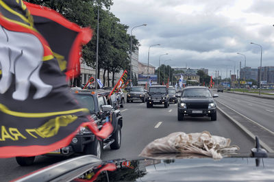 Traffic on road in city against sky