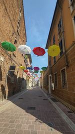 Street amidst buildings in city against sky