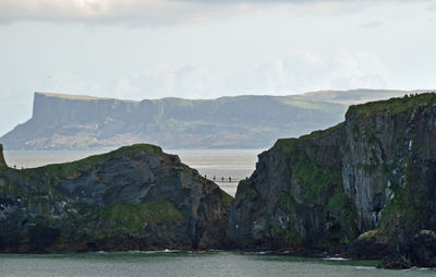 Scenic view of sea and mountains against sky