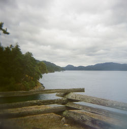 Scenic view of lake against cloudy sky