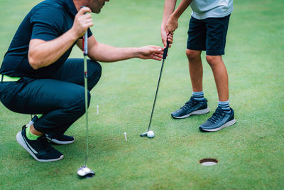 Low section of friends standing on golf course