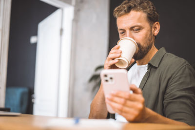 Young woman drinking coffee at home